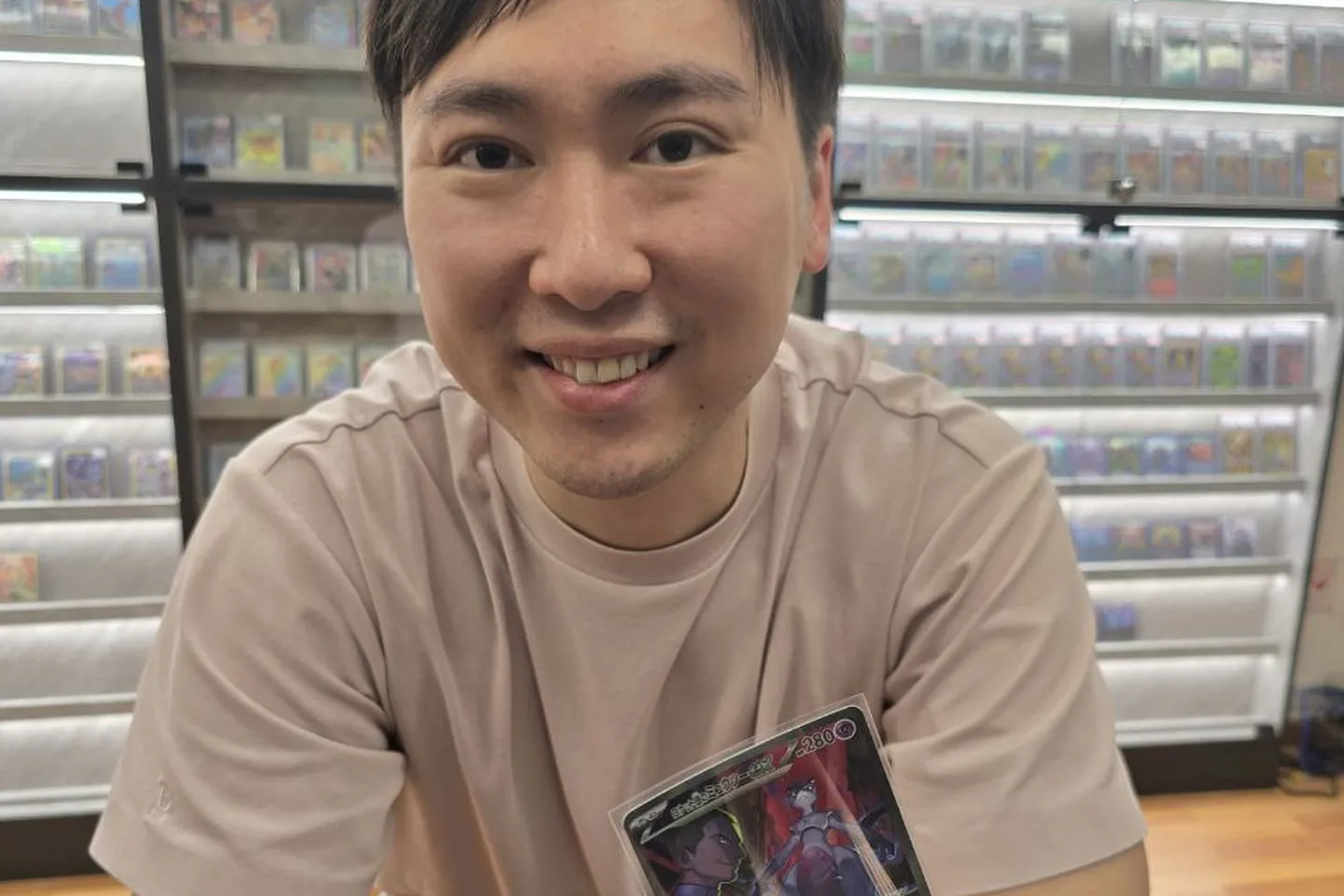 Collector holding up a card in front of the slab display wall.